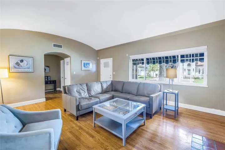 Living room offers fireplace and big bay windows.