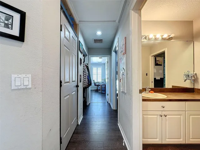 Hallway leads to 3 other bedrooms on this side and full bath.