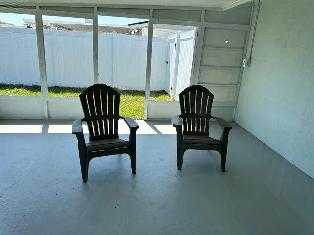 Large covered patio overlooking the freshly sodded fenced back yard.