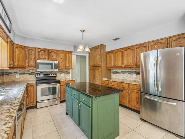 All SS appliances, granite counters and wood cabinets