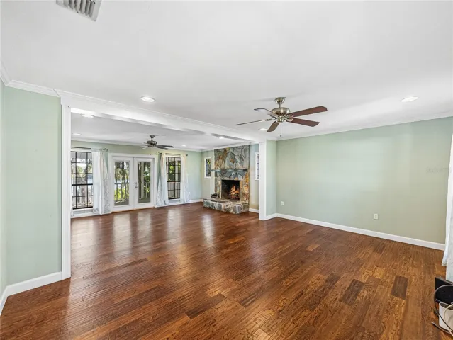 Living room looking into Family room with stone fireplace