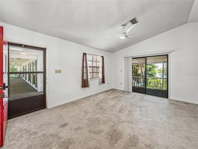 Cottage entry sliding doors lead to the screen porch overlooking lake