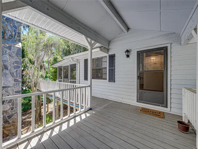 covered porch connects house to cottage