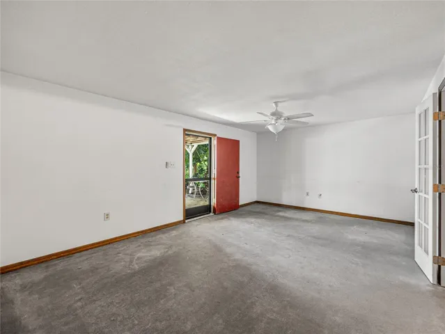 Basement living area with walk out door to covered patio overlooking lake