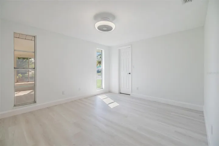 2nd bedroom with walk-in closet.  Fan and light on ceiling.