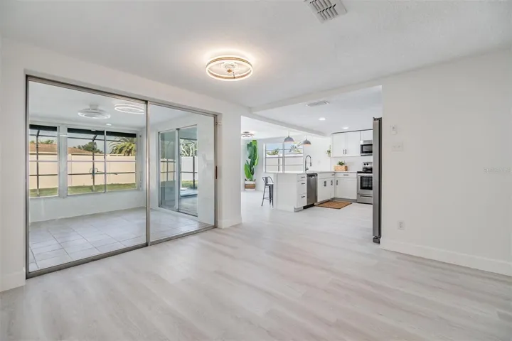 Dining room over looking the kitchen and flex room. Slider doors in each area