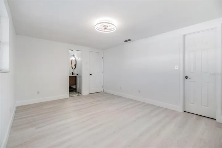Primary Bedroom with walk in closet and entrance into bathroom