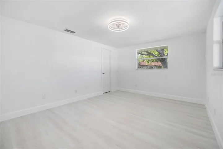 Primary Bedroom with light and fan