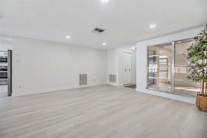 Living room with view into front enclosed porch