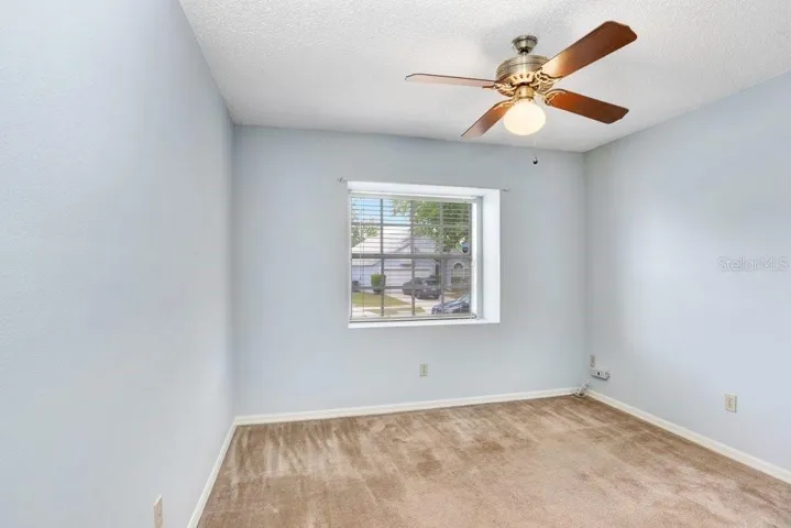 The second bedroom has an adorable window space to sit in or to display some of your favorite plants or collections.  It also features a lighted ceiling fan and a good-sized closet.