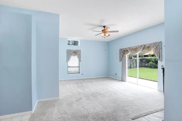 Inside you'll find an open floorplan, a decorative fireplace that will stay, a beautiful chandelier in the dining room, a large sliding glass door to the backyard, a lighted ceiling fan, and lots of natural light!