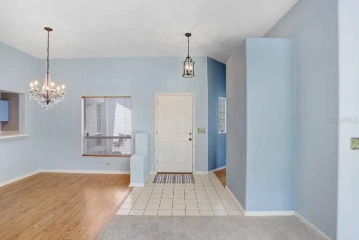 Inside you'll find an open floorplan, a decorative fireplace that will stay, a beautiful chandelier in the dining room, a large sliding glass door to the backyard, a lighted ceiling fan, and lots of natural light!