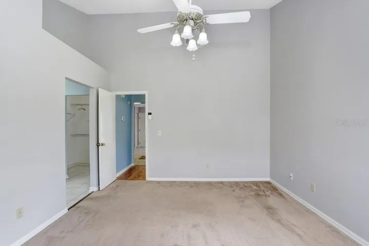 The master bedroom is spacious and features a slider to the back porch, a walk-in closet, a lighted ceiling fan, and a beautiful ensuite bathroom!