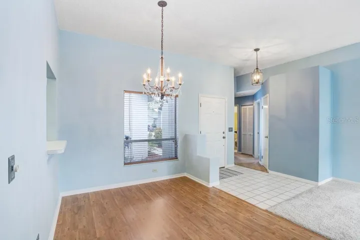 Inside you'll find an open floorplan, a decorative fireplace that will stay, a beautiful chandelier in the dining room, a large sliding glass door to the backyard, a lighted ceiling fan, and lots of natural light!