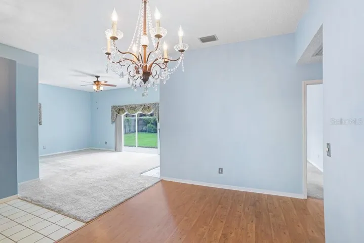 Inside you'll find an open floorplan, a decorative fireplace that will stay, a beautiful chandelier in the dining room, a large sliding glass door to the backyard, a lighted ceiling fan, and lots of natural light!