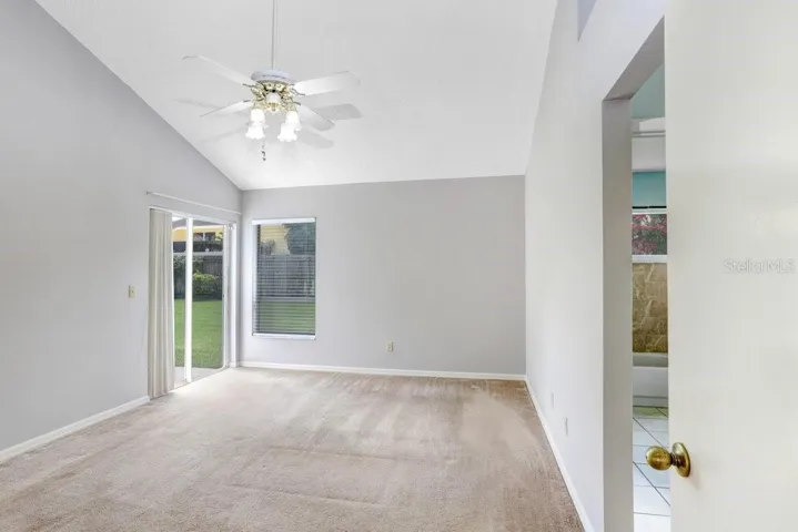 The master bedroom is spacious and features a slider to the back porch, a walk-in closet, a lighted ceiling fan, and a beautiful ensuite bathroom!