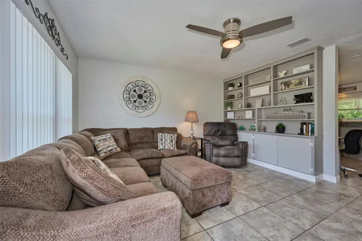 Living room has built-in shelving and a nice big window!