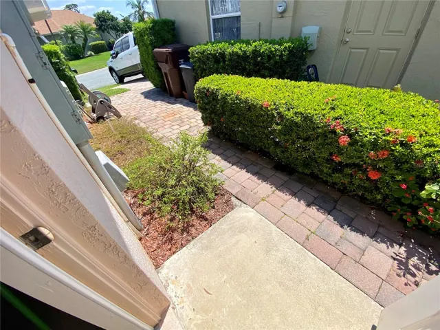 Side of home with landscaping and pavers
