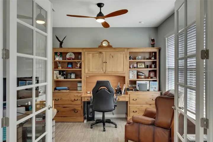 Office off hallway with double glass doors.
