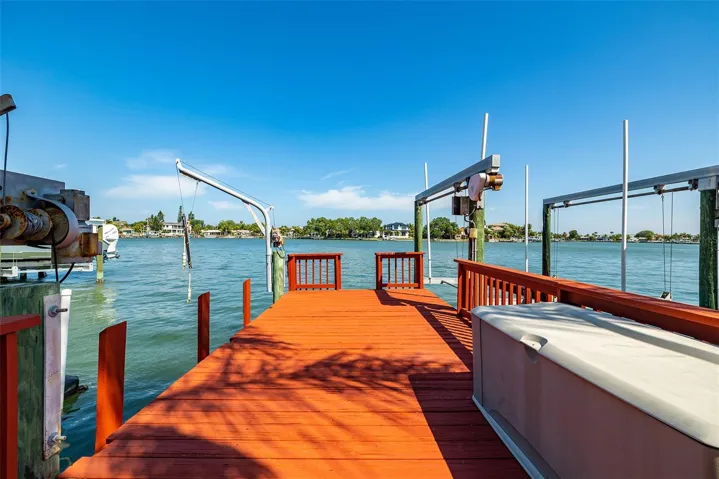 Wood dock with lower level on left and front side for easy access to kayaking and paddleboarding