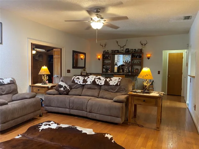 Living room looking towards the dining room.  Door at the back right of the picture leads is a linen closet with guest bedrooms to the right and left.