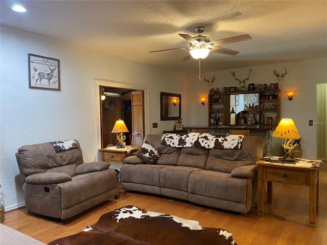 The by-fold doors to the back left of the picture lead to the 8' x 22' room that could be used as a private office.