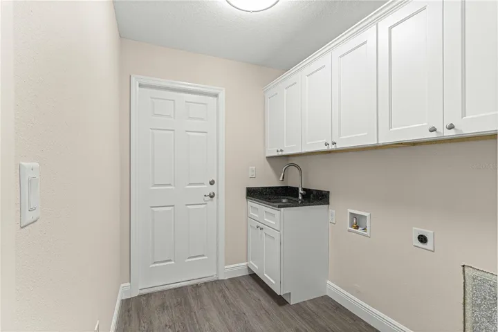LAUNDRY ROOM WITH SINK AND PLENTY OF CABINET SPACE