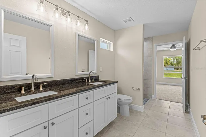 JACK AND JILL BATHROOM WITH DUAL GRANITE COUNTERTOP SINKS