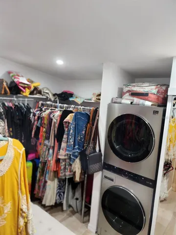 Stackable washer dryer in primary walk in closet
