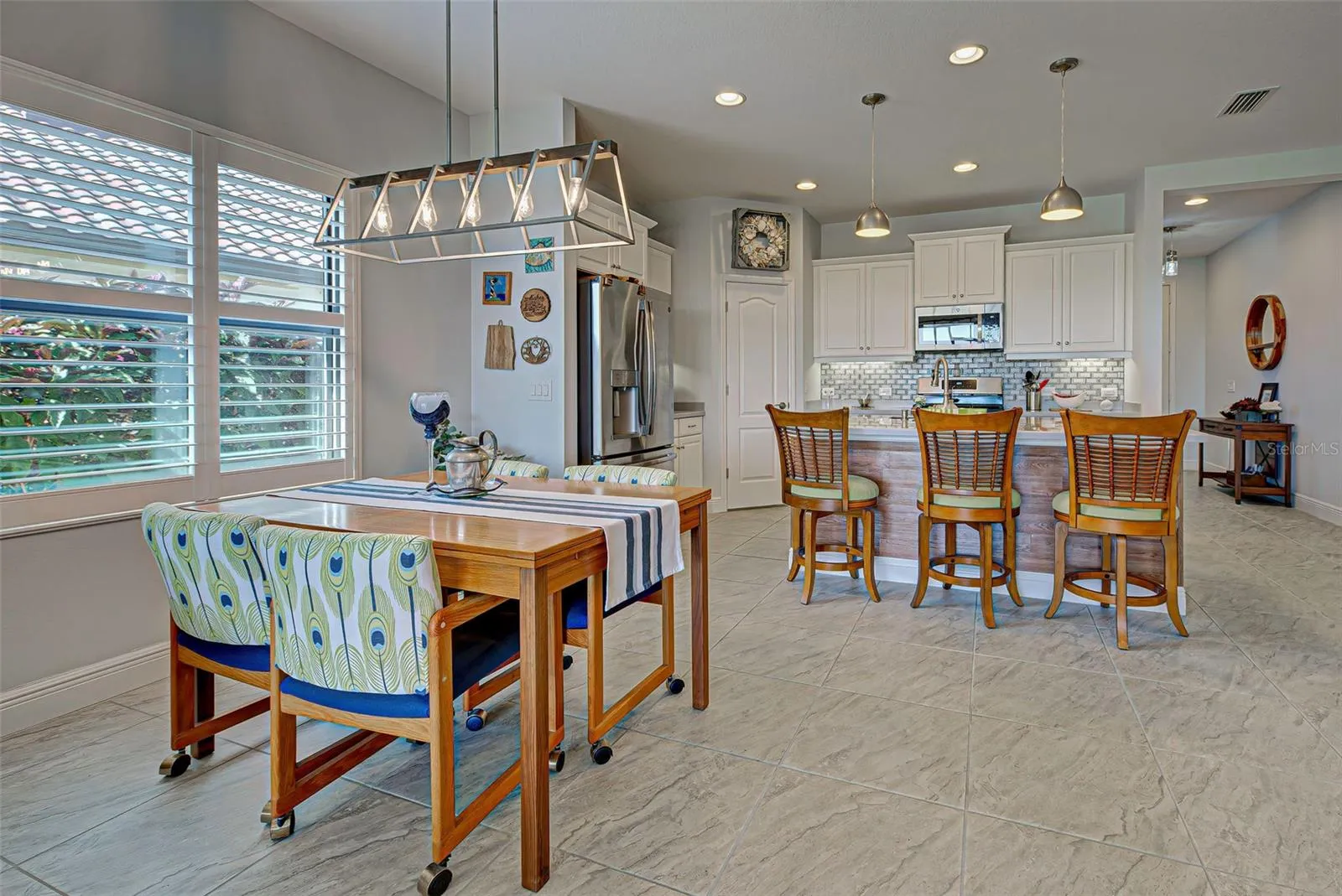 DINETTE AREA - KITCHEN BAR - OR TAKE IT TO THE PATIO FOR YOUR DINING CHOICES.