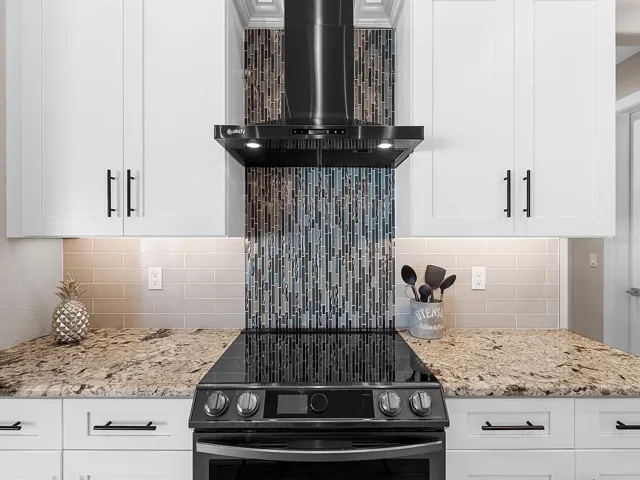Shaker cabinets and the blue tile. Stunning!