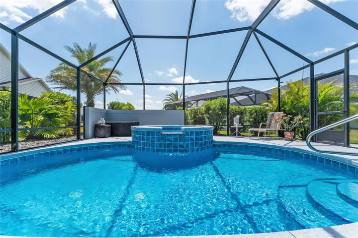 POOL & SPA waterfall feature is pictured here. Imagine the relaxing sounds of the water gently pouring over the ledge. Yes, here is your SLICE OF PARADISE!