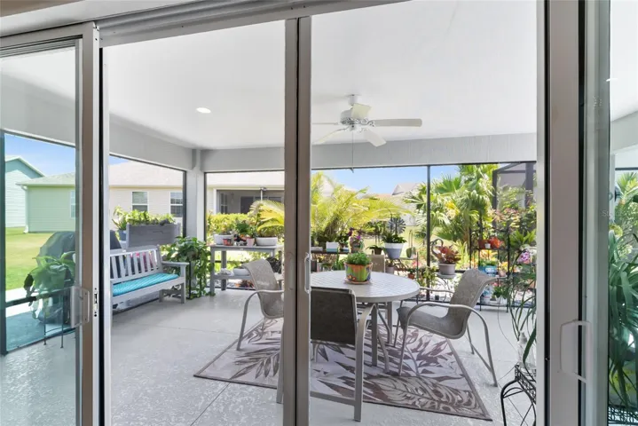 SCREEN ENCLOSED LANAI - When SLIDING GLASS DOORS are stacked back, you can use HIDDEN SCREEN DOORS to cross ventilate during the balmy winters in Florida.