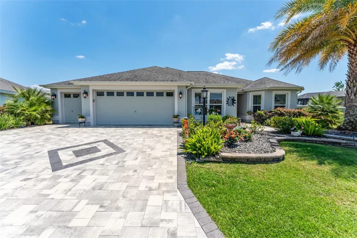 FRONT EXTERIOR view shows complementary colors of the PAVERED driveway and walkway.