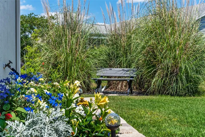 REAR EXTERIOR - View of BUTTERFLY GARDEN in backyard. Sitting bench has REAR PRIVACY from the landscaping design.