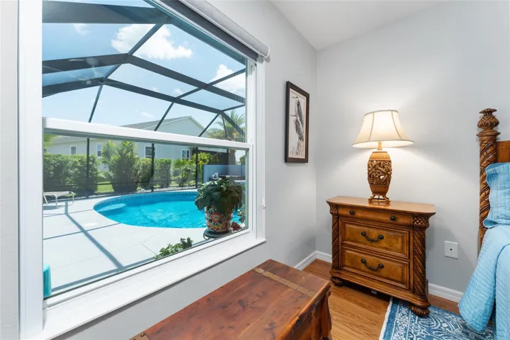 BEDROOM #2  (back of home) features picture perfect view of enclosed pool area