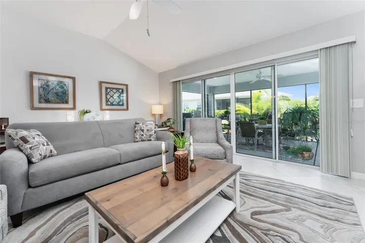 LIVING ROOM view showing STACK BACK SLIDING GLASS DOORS to SCREEN ENCLOSED LANAI