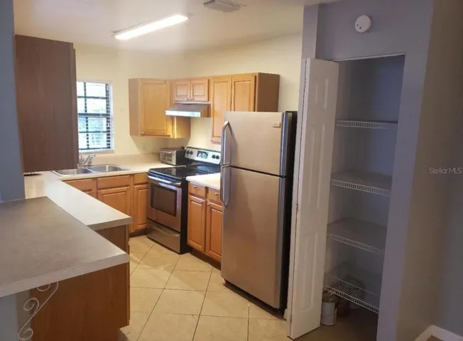 Kitchen w/ eat at bar and pantry