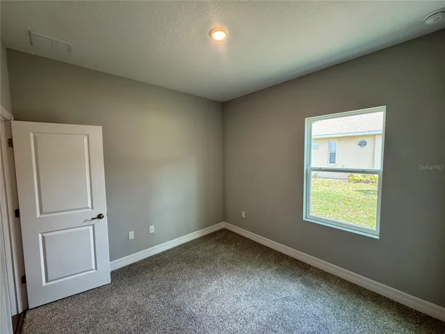 Bedroom 3 with walk in Closet (toward Garage)