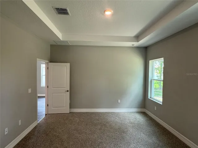 Primary Bedroom with Primary Bath and closets behind you