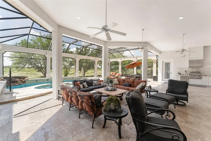 Another view of OPEN LANAI & massive MANSARD SCREENED POOL ENCLOSURE - what a fantastic OUTDOOR OASIS for entertaining & relaxation!