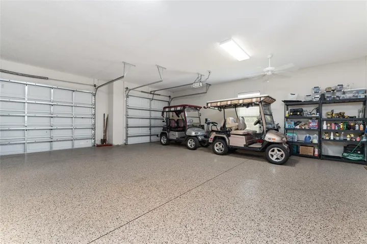 EXTENDED 3 CAR GARAGE with ~1200 SF, featuring EPOXY garage floor finish, two ceiling fans, and plenty of room for tandem parking for two golf carts!