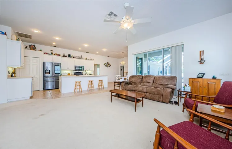 Spacious living room looking towards kitchen with breakfast bar.
