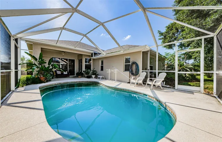 screened lanai pool and covered area by sliders