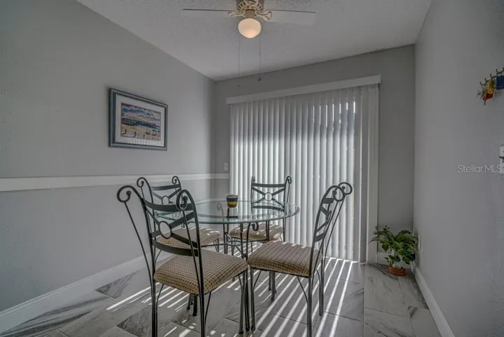 Dinette with sliders to front courtyard with tile floor