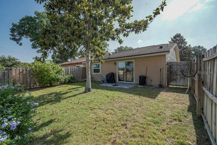 View of fenced rear yard with patio