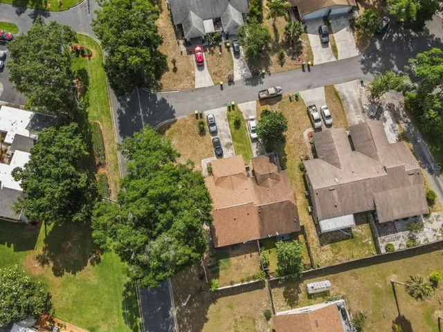 Aerial View of house with fenced yard and Magnolia tree