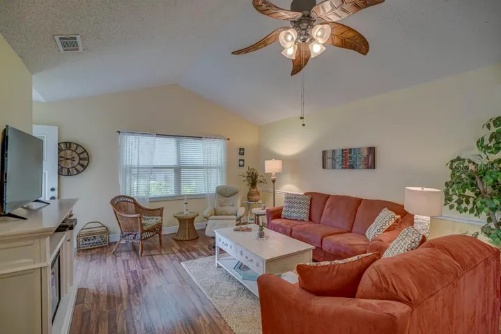 Living Room with vaulted ceiling laminate flooring
