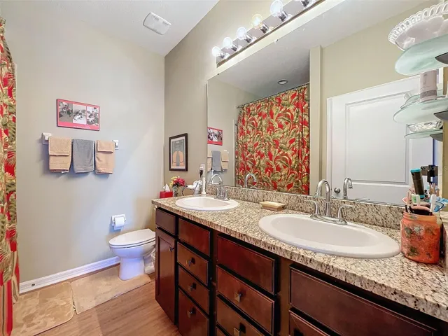 En suite with granite counters  and dual sinks