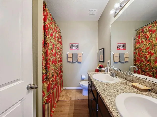 En Suite with Low Threshold Shower, Dual Sinks, and Linen Closet